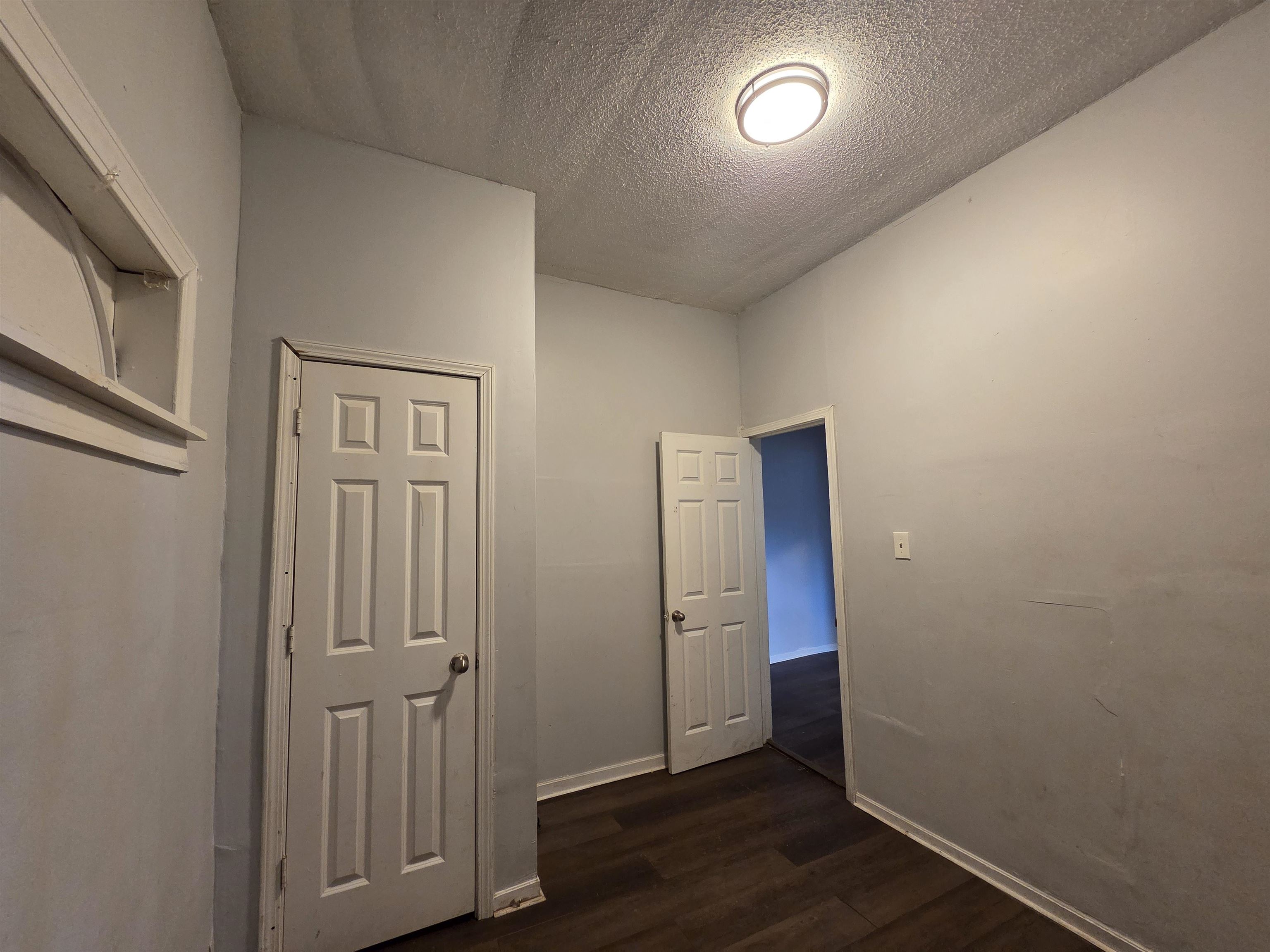 993 Oakview Street, Unit 201 Memphis, TN 38114 - Photo 7 of 16 an empty room with wooden floor and windows