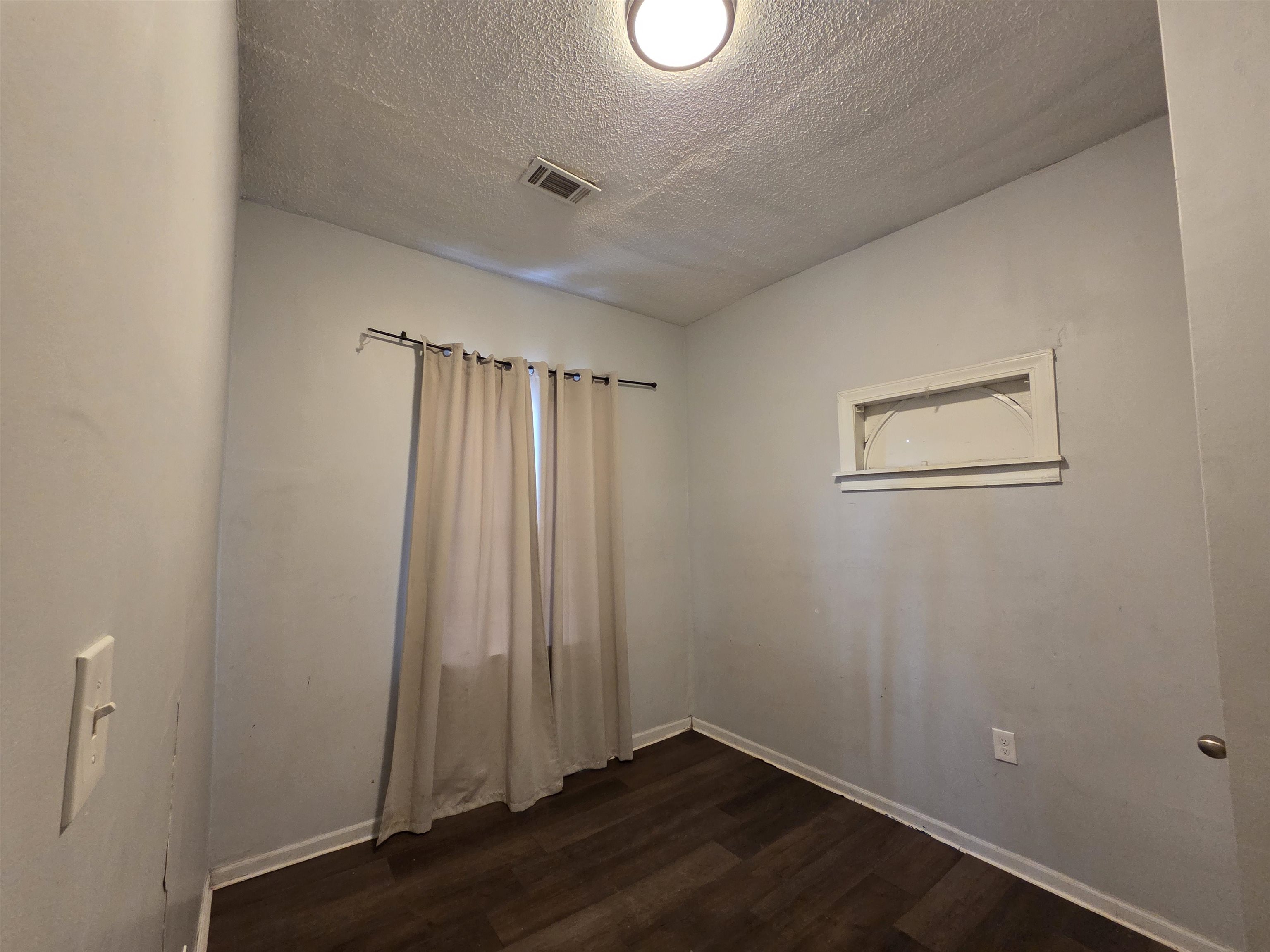 993 Oakview Street, Unit 201 Memphis, TN 38114 - Photo 8 of 16 an empty room with wooden floor and windows
