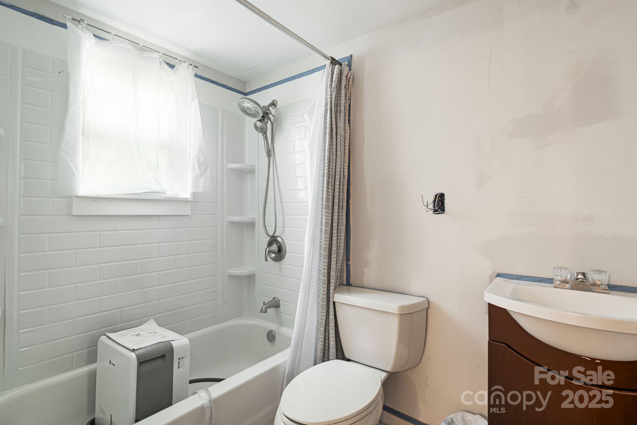 609 Maple Street Brevard, NC 28712 - Photo 18 of 28 a bathroom with a sink toilet and shower