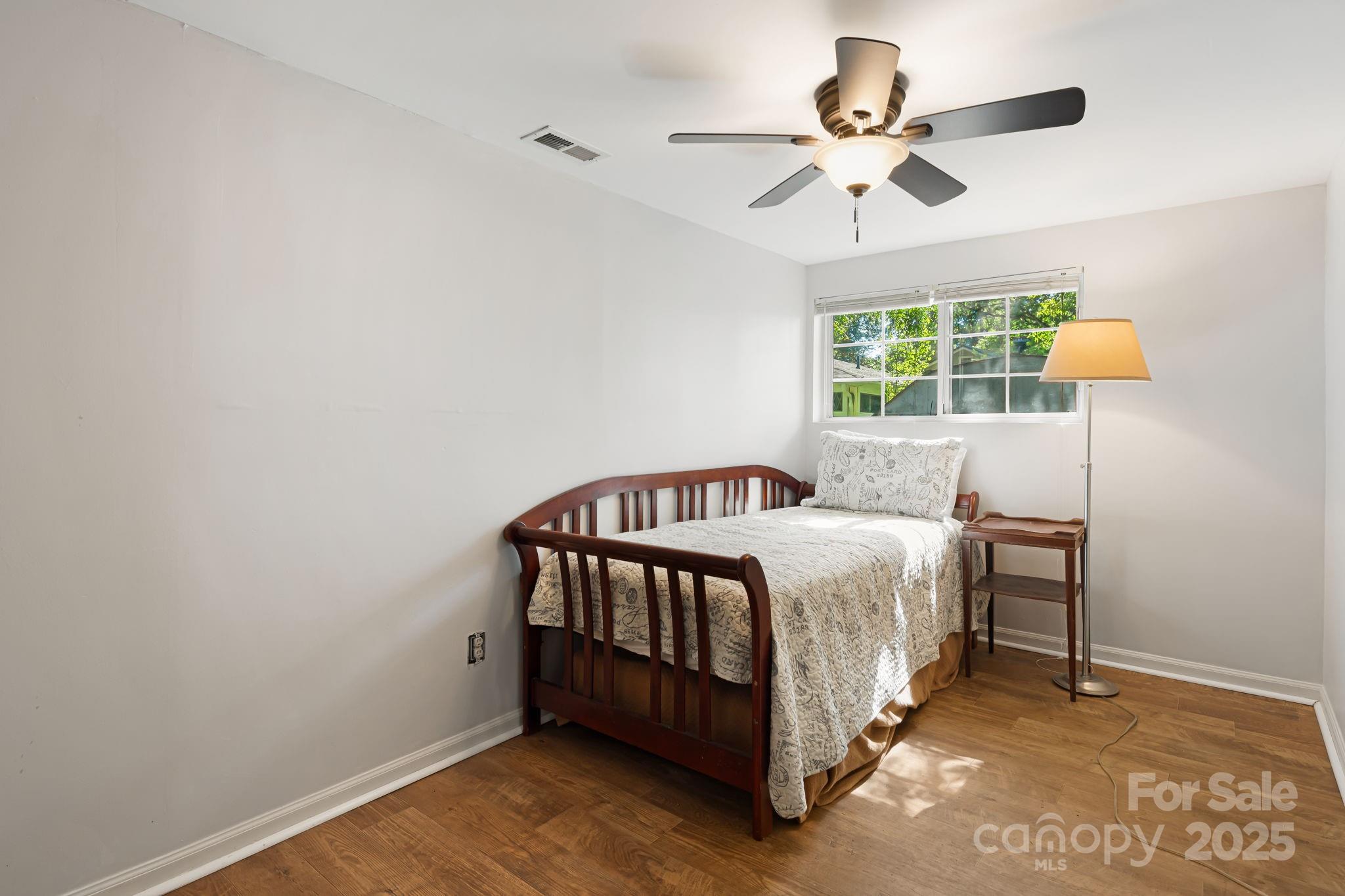 609 Maple Street Brevard, NC 28712 - Photo 20 of 28 a bed sitting in a bedroom next to a window