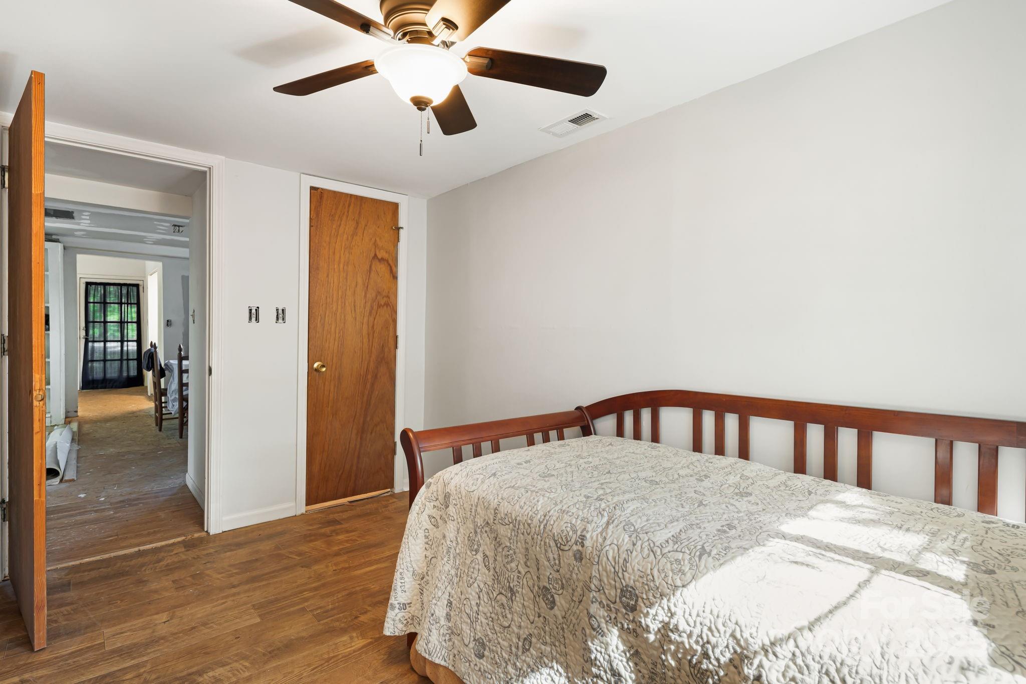 609 Maple Street Brevard, NC 28712 - Photo 21 of 28 a bedroom with a bed and wooden floor