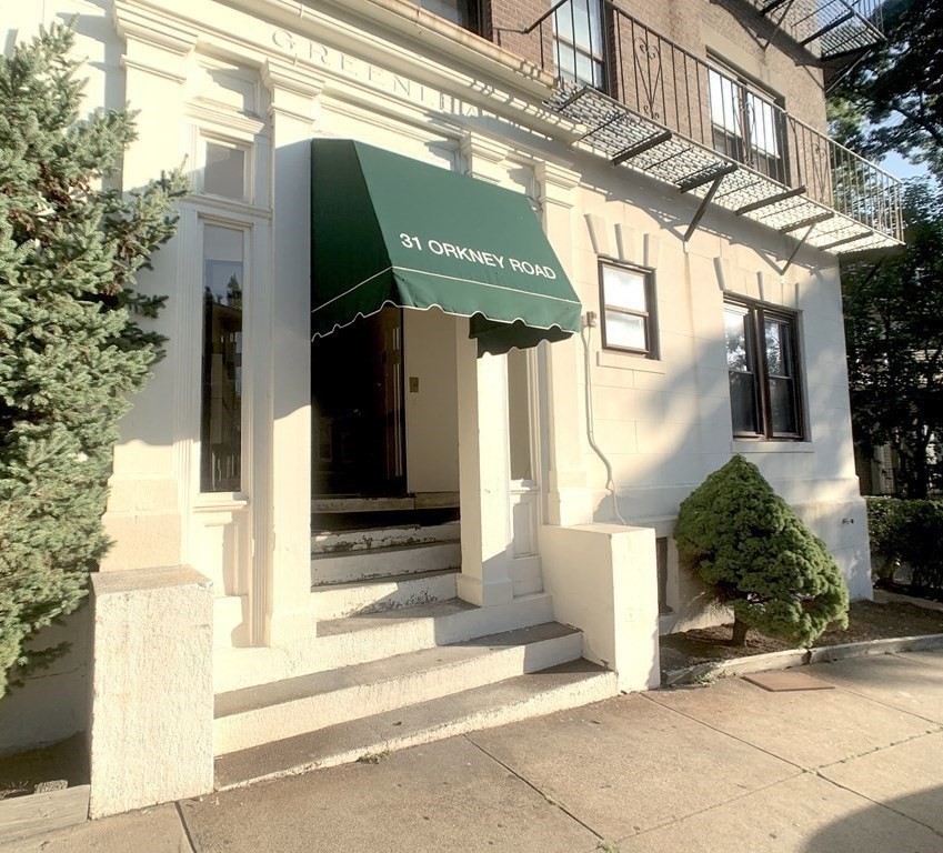 a view of a house with a windows and plants