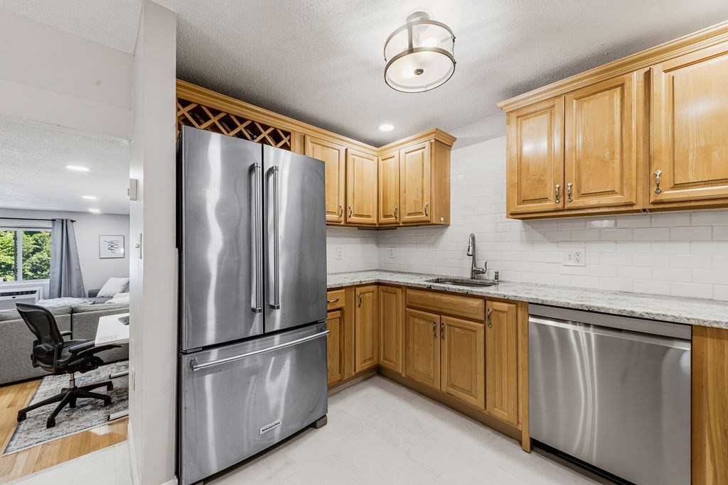 10 Erick Road, Unit 42 Mansfield, MA 02048 - Photo 16 of 33 a kitchen with stainless steel appliances granite countertop a refrigerator a sink dishwasher a stove and a refrigerator