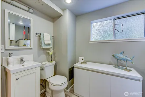 a bathroom with a sink mirror and toilet