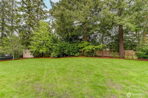 a view of a field of grass and trees