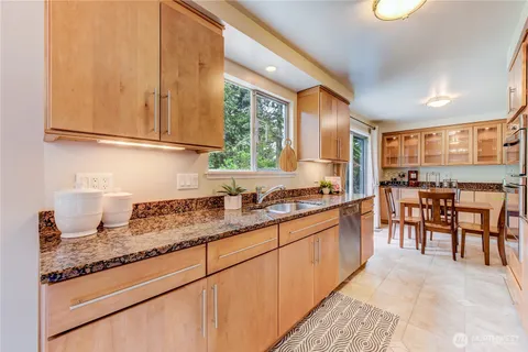 a kitchen with granite countertop sink cabinets and window
