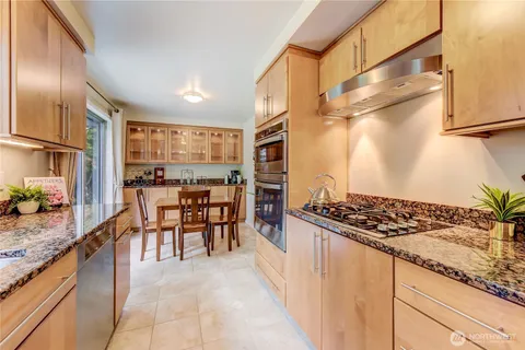 a kitchen with granite countertop lots of counter top space and stainless steel appliances