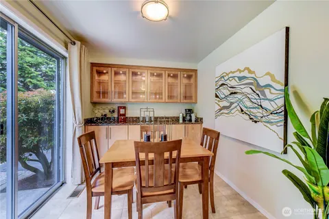 a dining room with furniture and a floor to ceiling window
