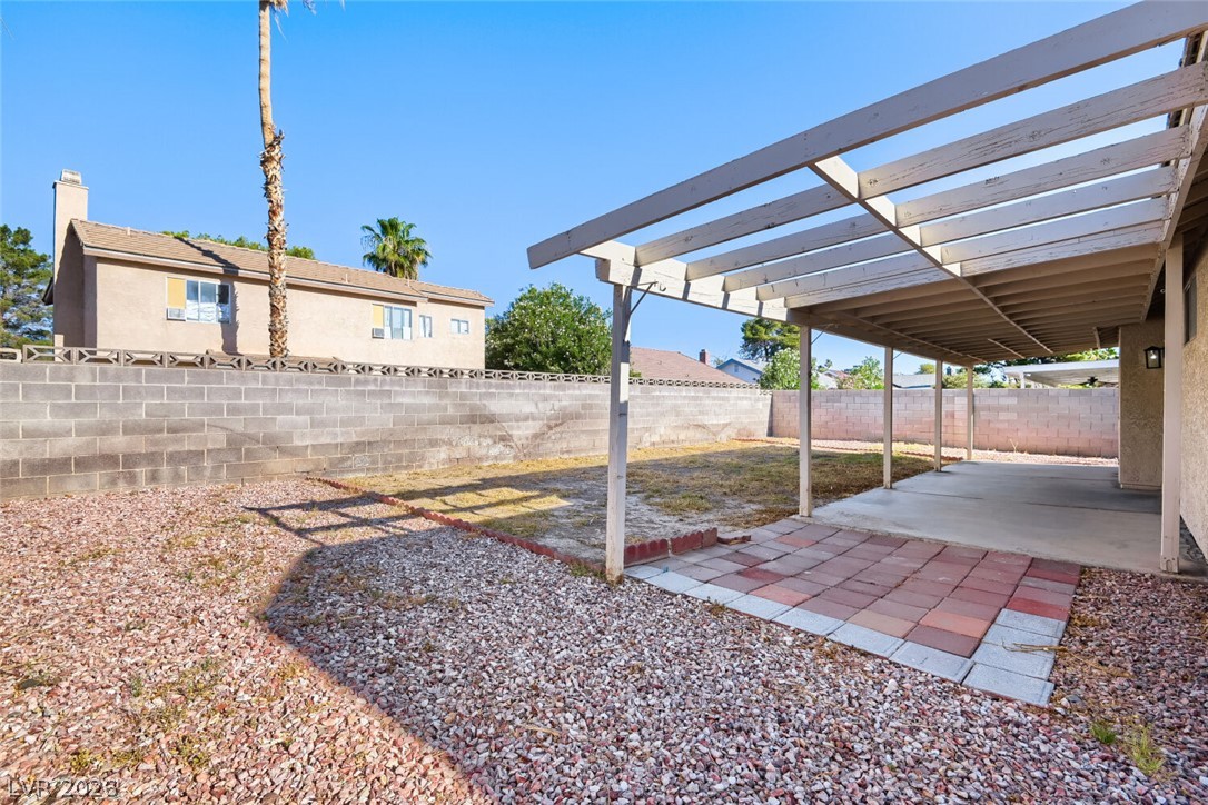 2343 Valleywood Road Henderson, NV 89014 - Photo 28 of 29 An inviting covered patio and spacious backyard offer ample room for outdoor activities.