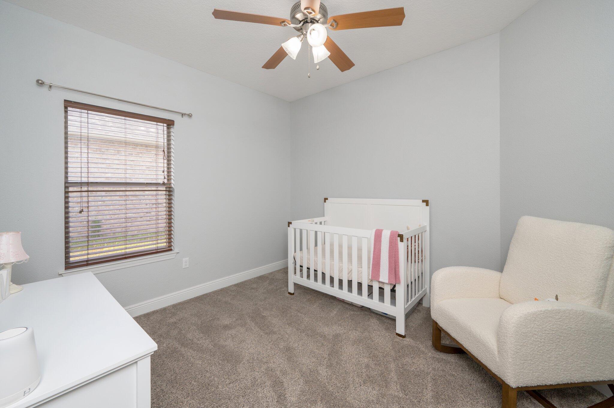 661 Red Fern Road Crestview, FL 32536 - Photo 11 of 28 a bedroom with a bed and a couch