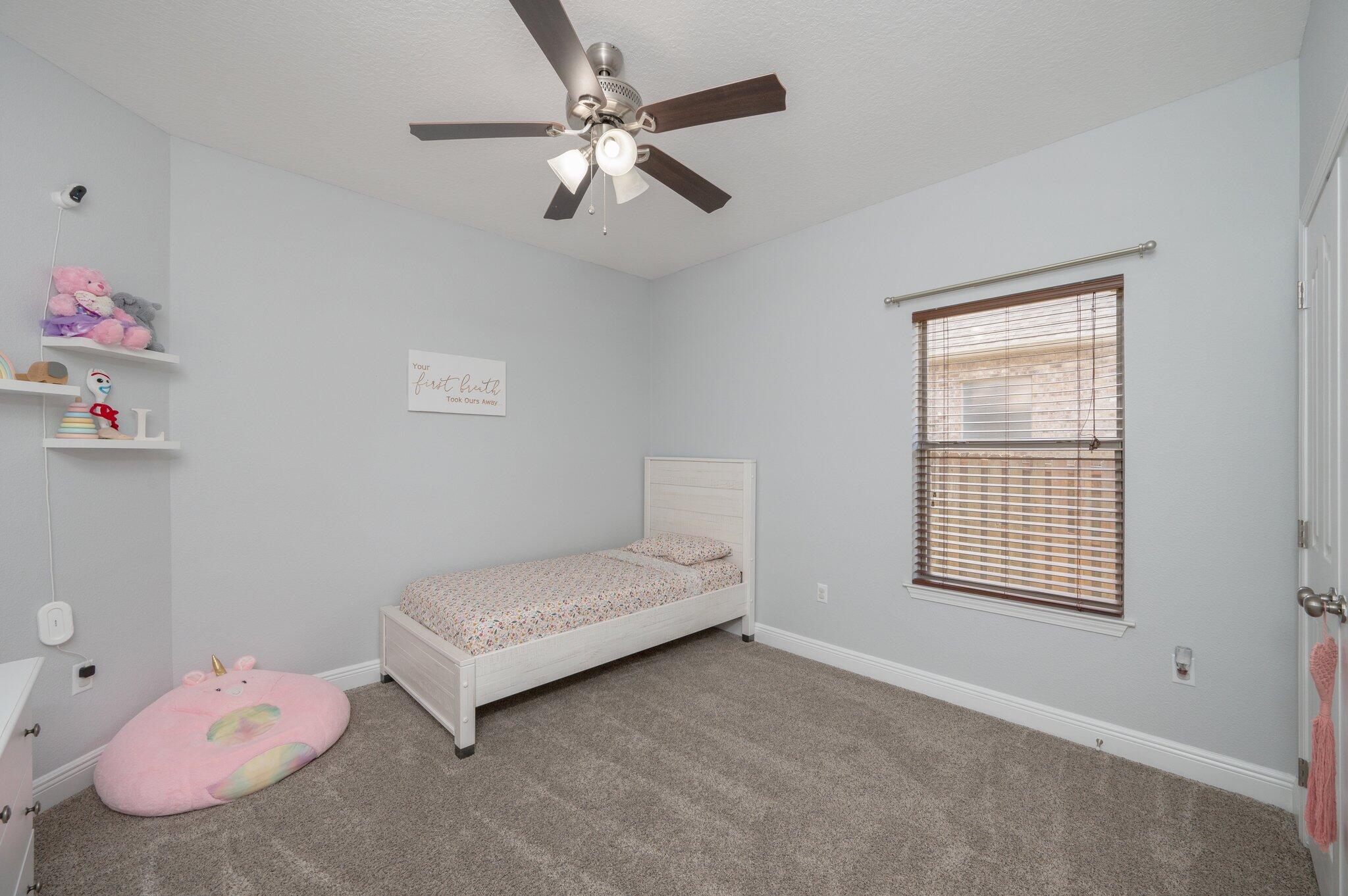 661 Red Fern Road Crestview, FL 32536 - Photo 13 of 28 a bedroom with a bed and a window