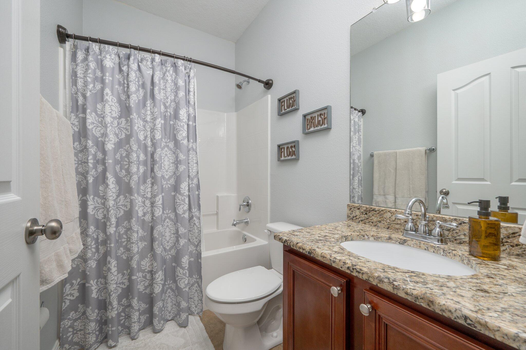 661 Red Fern Road Crestview, FL 32536 - Photo 15 of 28 a bathroom with a granite countertop sink toilet and shower