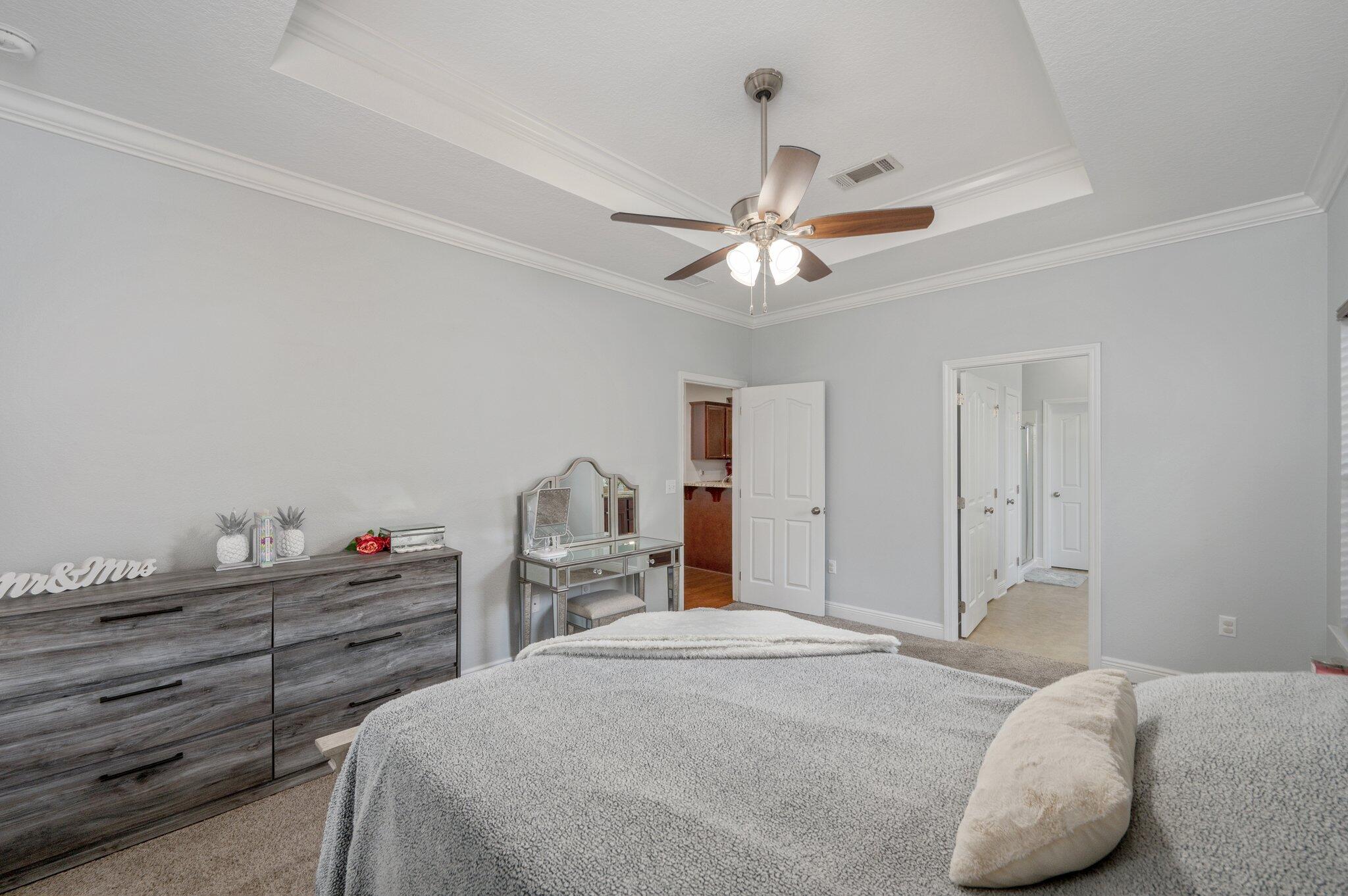 661 Red Fern Road Crestview, FL 32536 - Photo 18 of 28 a bedroom with a bed and a chandelier