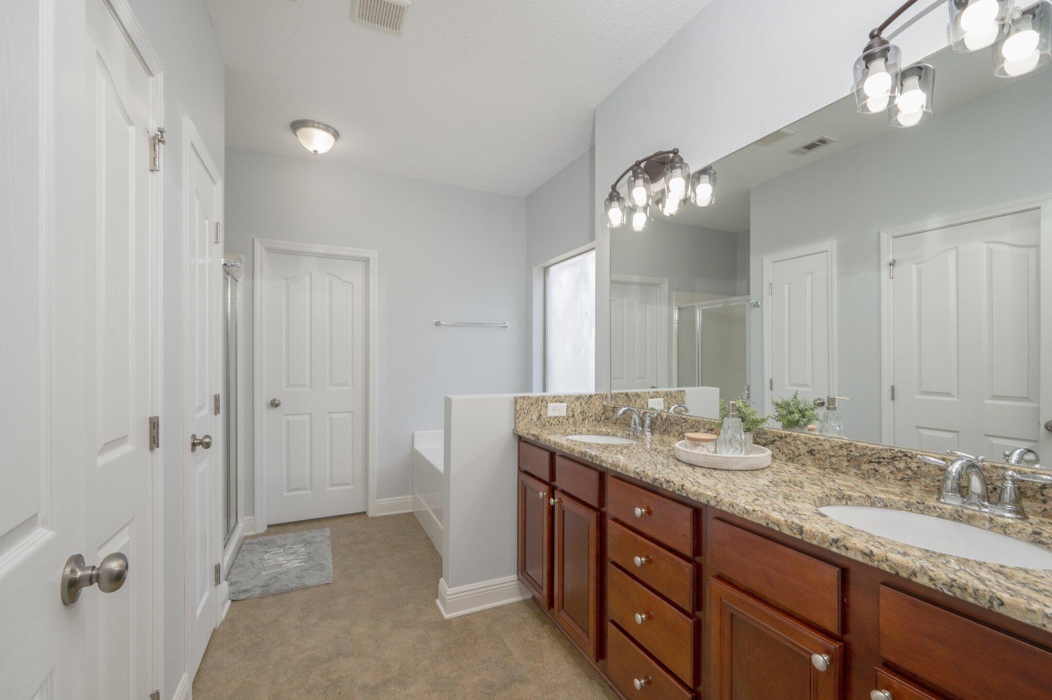 661 Red Fern Road Crestview, FL 32536 - Photo 19 of 28 a bathroom with a granite countertop double vanity sink and a mirror
