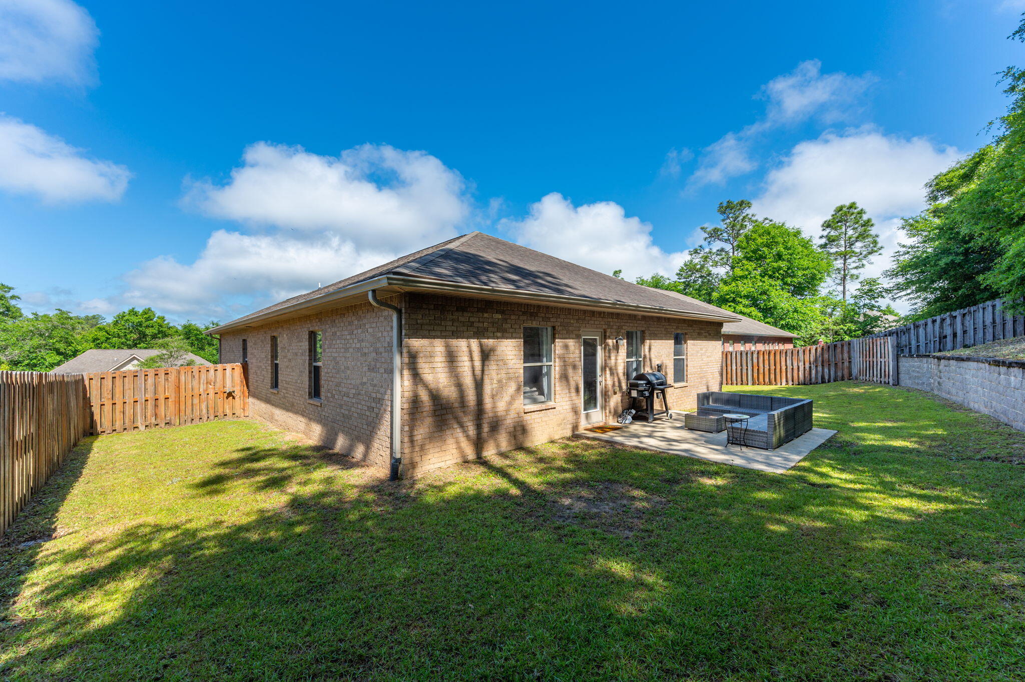 661 Red Fern Road Crestview, FL 32536 - Photo 26 of 28 a backyard of a house with table and chairs