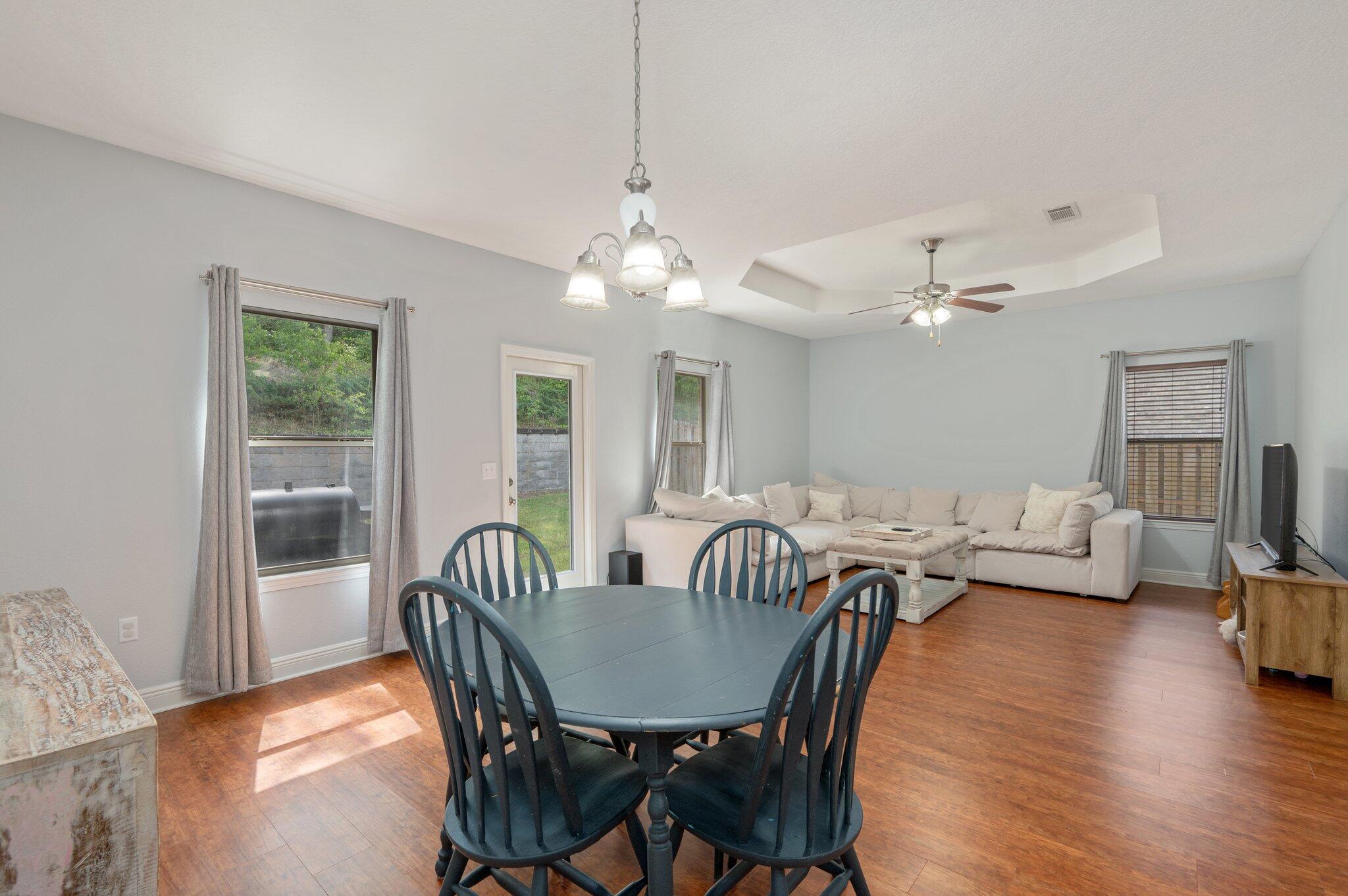 661 Red Fern Road Crestview, FL 32536 - Photo 4 of 28 a view of a dining room with furniture wooden floor and chandelier