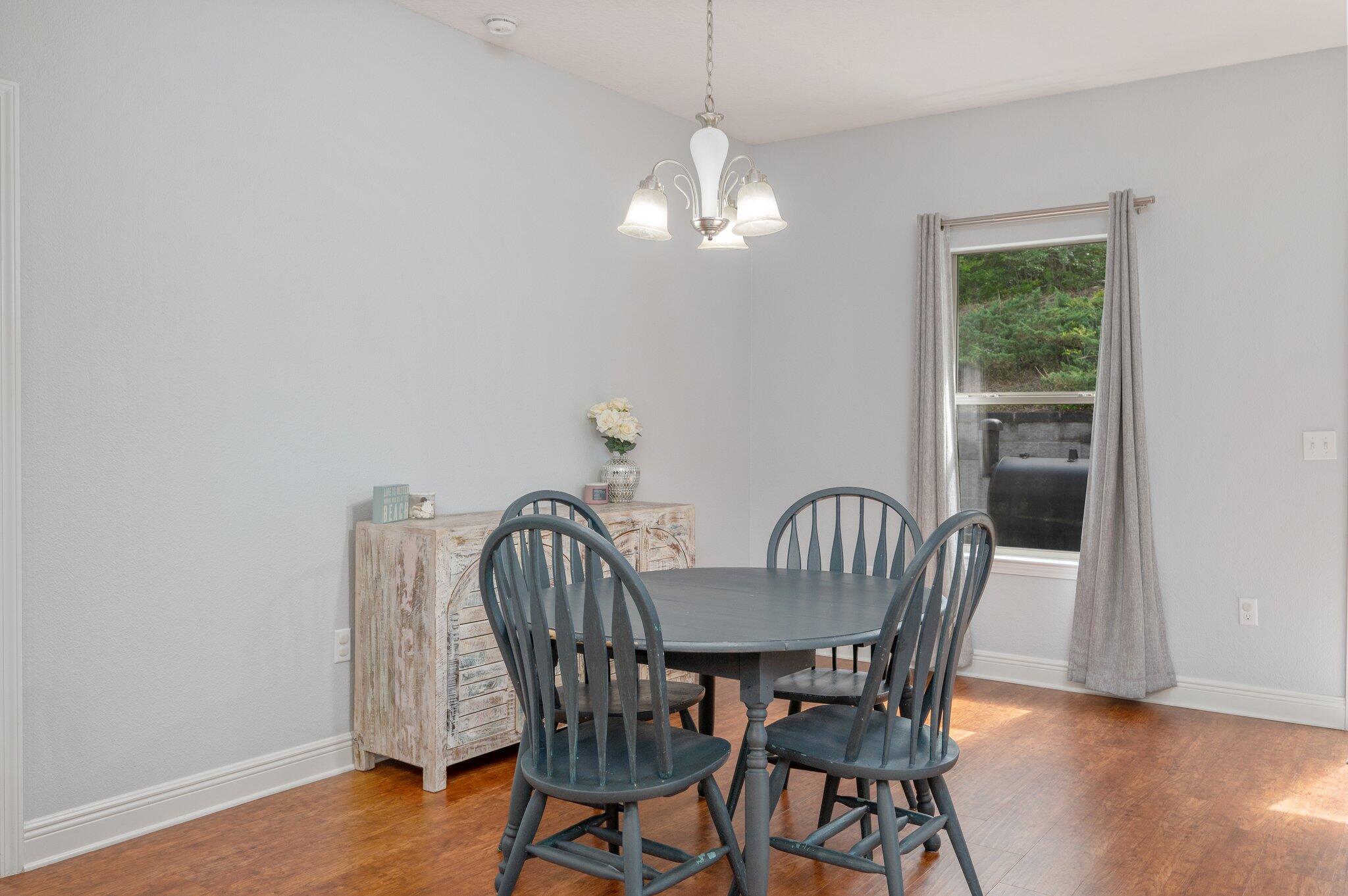 661 Red Fern Road Crestview, FL 32536 - Photo 5 of 28 a view of a dining room with furniture wooden floor and chandelier