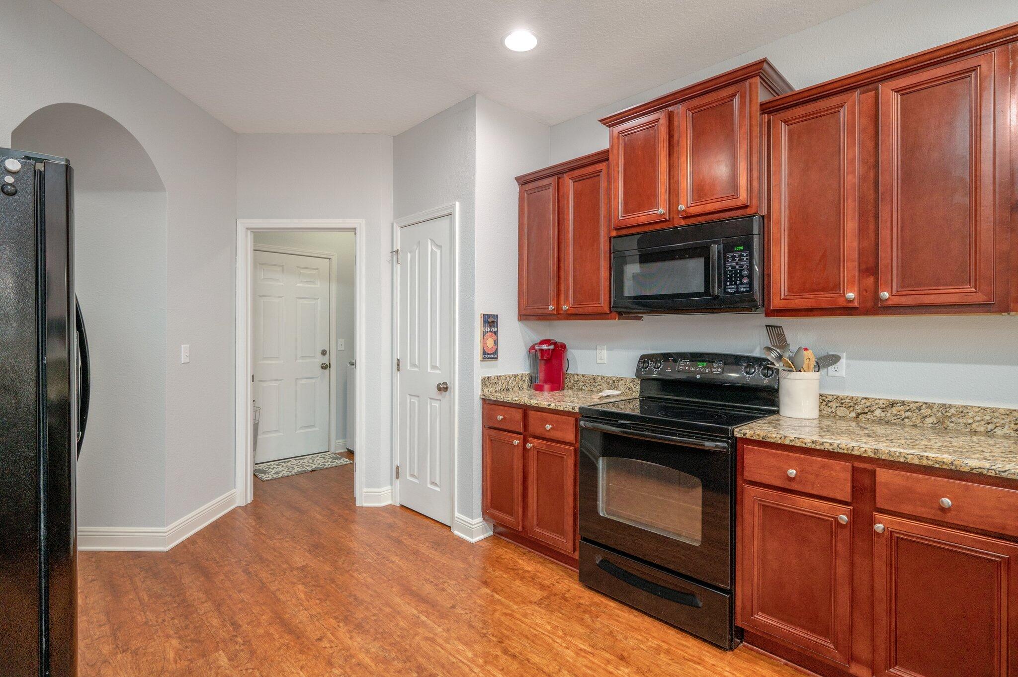 661 Red Fern Road Crestview, FL 32536 - Photo 6 of 28 a kitchen with stainless steel appliances granite countertop a stove a sink dishwasher a refrigerator and a microwave oven