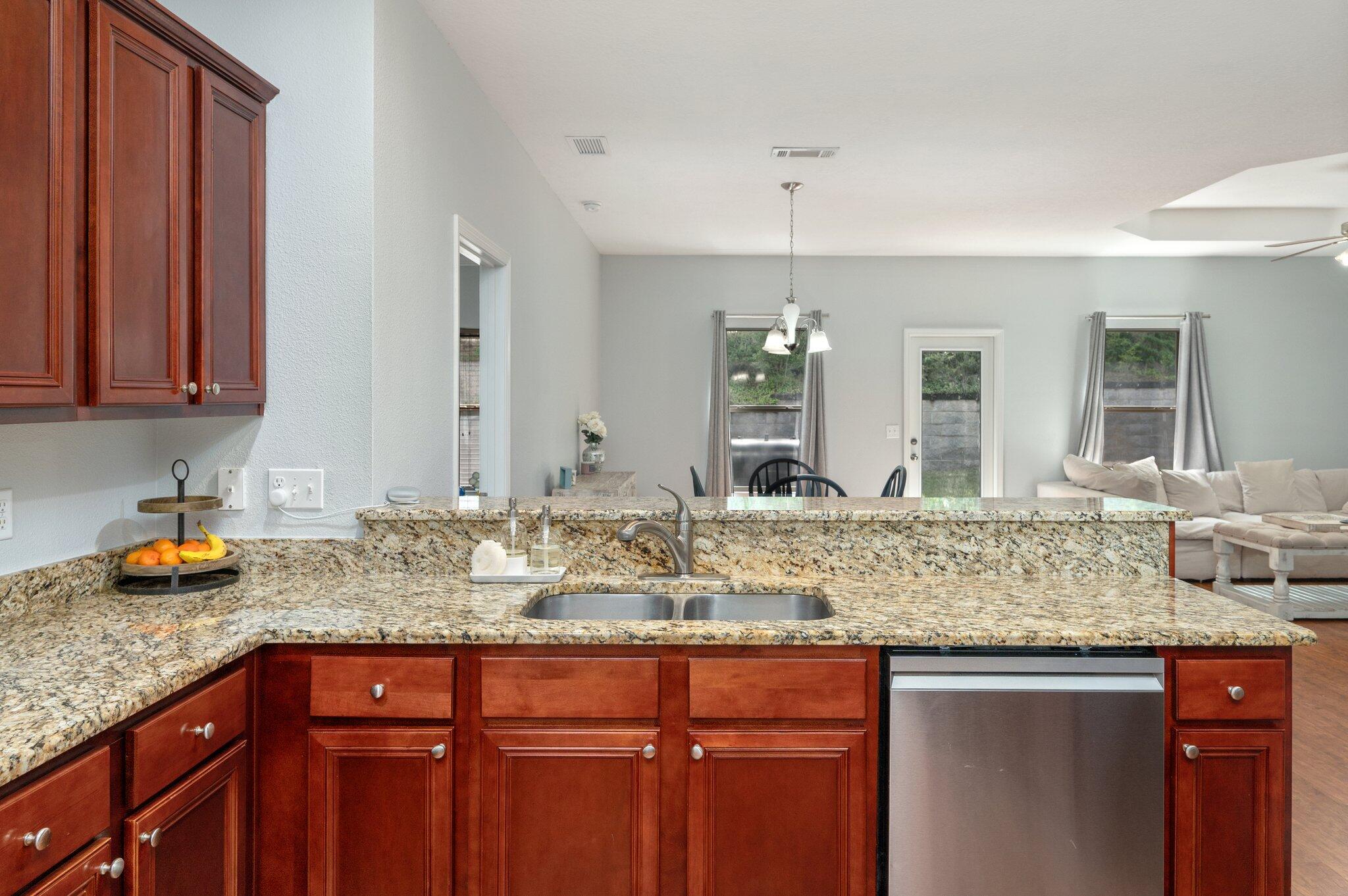 661 Red Fern Road Crestview, FL 32536 - Photo 8 of 28 a kitchen with granite countertop a sink and cabinets
