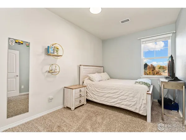 a bedroom with a bed and a table in it