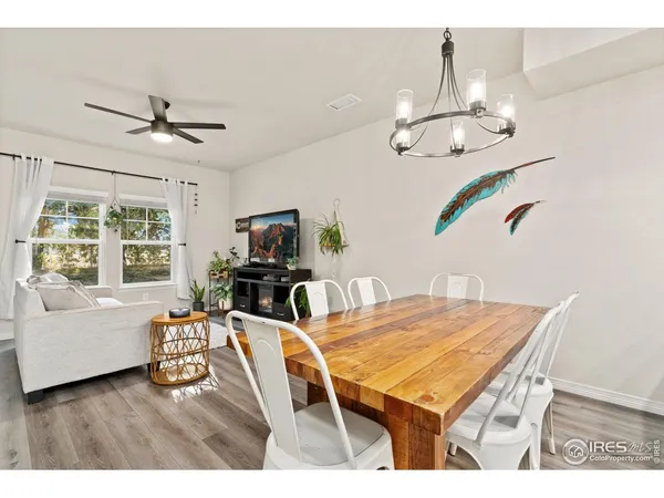 a room with chandelier furniture and wooden floor