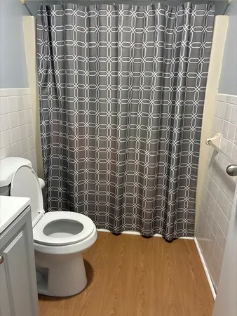 a bathroom with a toilet and a shower