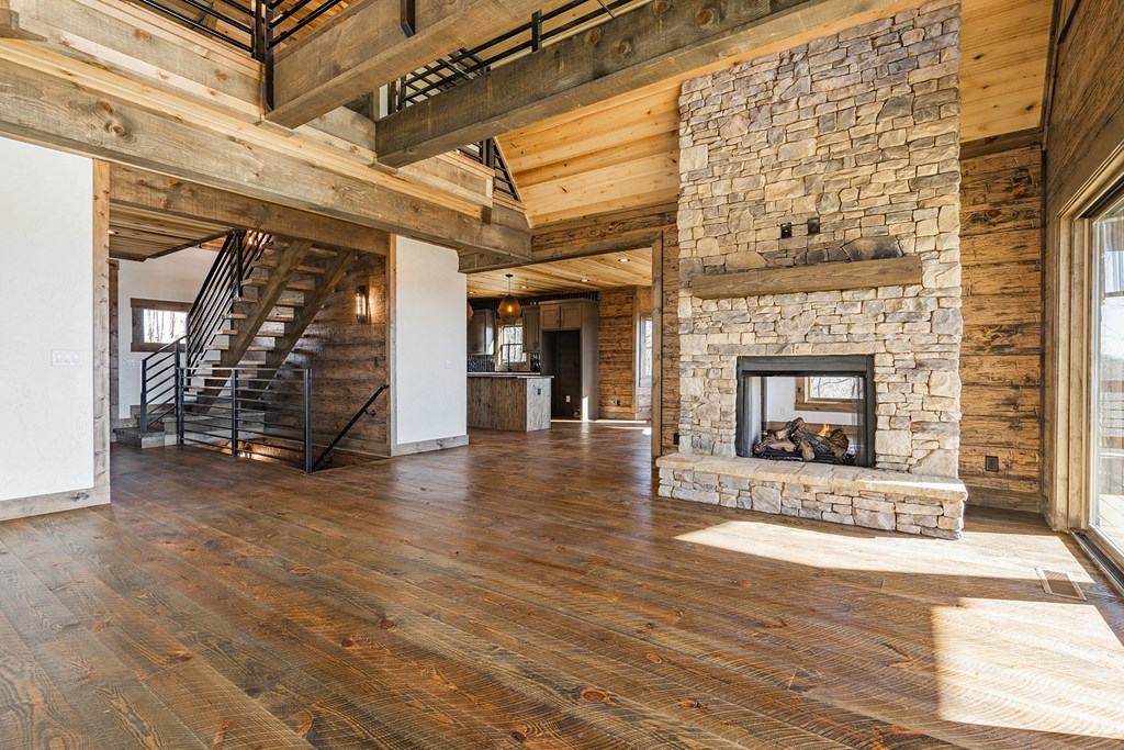 925 Heards Ridge Morganton, GA 30560 - Photo 15 of 70 an empty room with wooden floor fireplace and windows