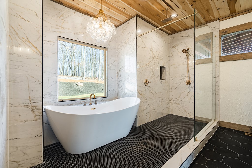 925 Heards Ridge Morganton, GA 30560 - Photo 29 of 70 a bath tub sitting in a bathroom next to a shower