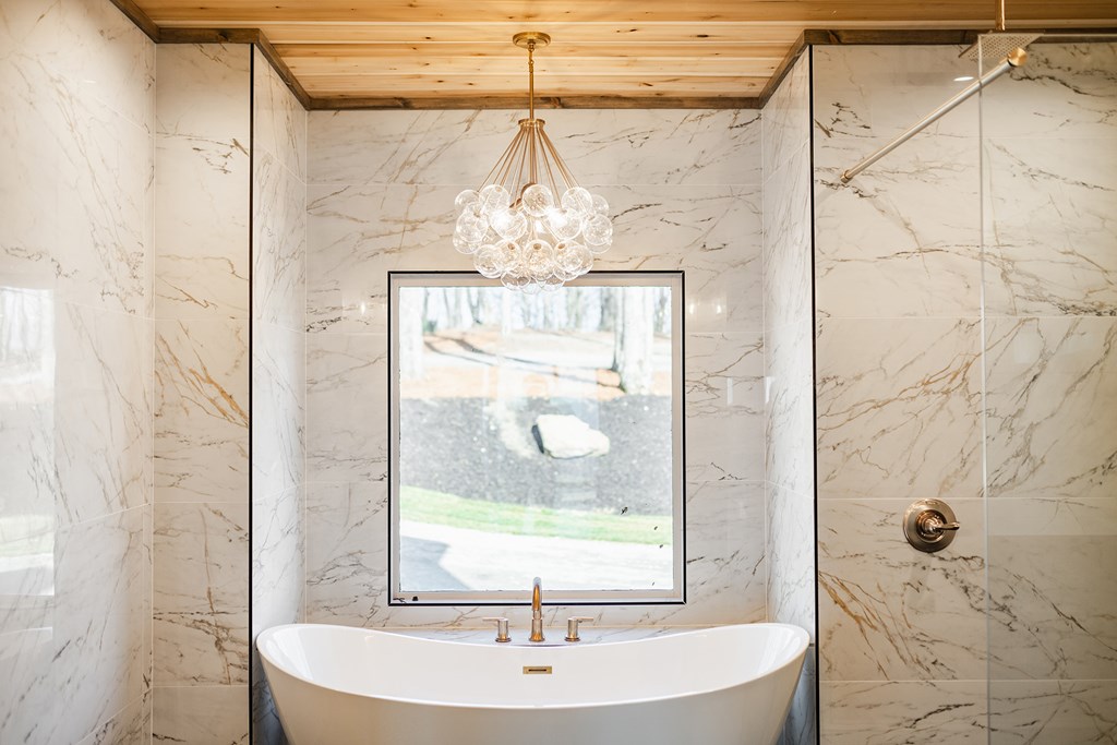 925 Heards Ridge Morganton, GA 30560 - Photo 32 of 70 a bathroom with a shower a window and a sink