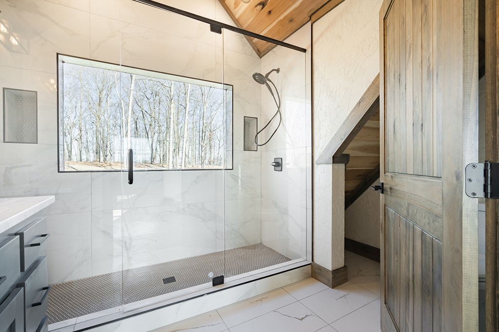 925 Heards Ridge Morganton, GA 30560 - Photo 49 of 70 a bathroom with a glass shower door and a window