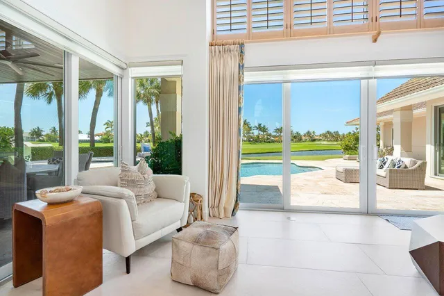 a living room with furniture ceiling fan and a chandelier