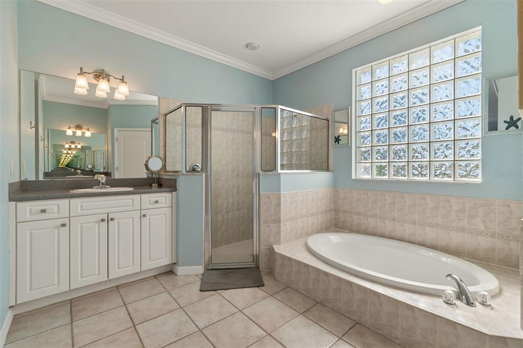 703 Bunker View Drive Apollo Beach, FL 33572 - Photo 21 of 49 a bathroom with a granite countertop sink a toilet and shower