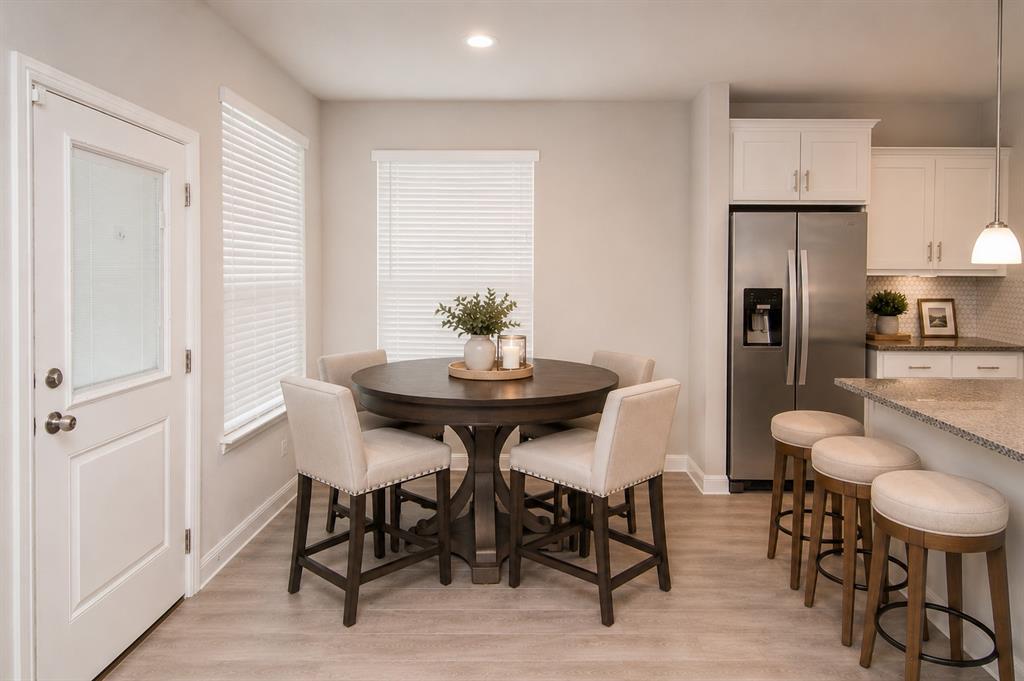1804 Mensa Drive Haslet, TX 76052 - Photo 7 of 30 Bright dining area featuring wood-finish flooring and a kitchen with white cabinetry