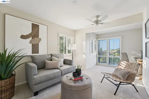 a living room with furniture and a potted plant