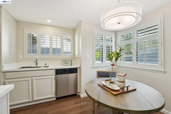a kitchen with a sink cabinets and wooden floor