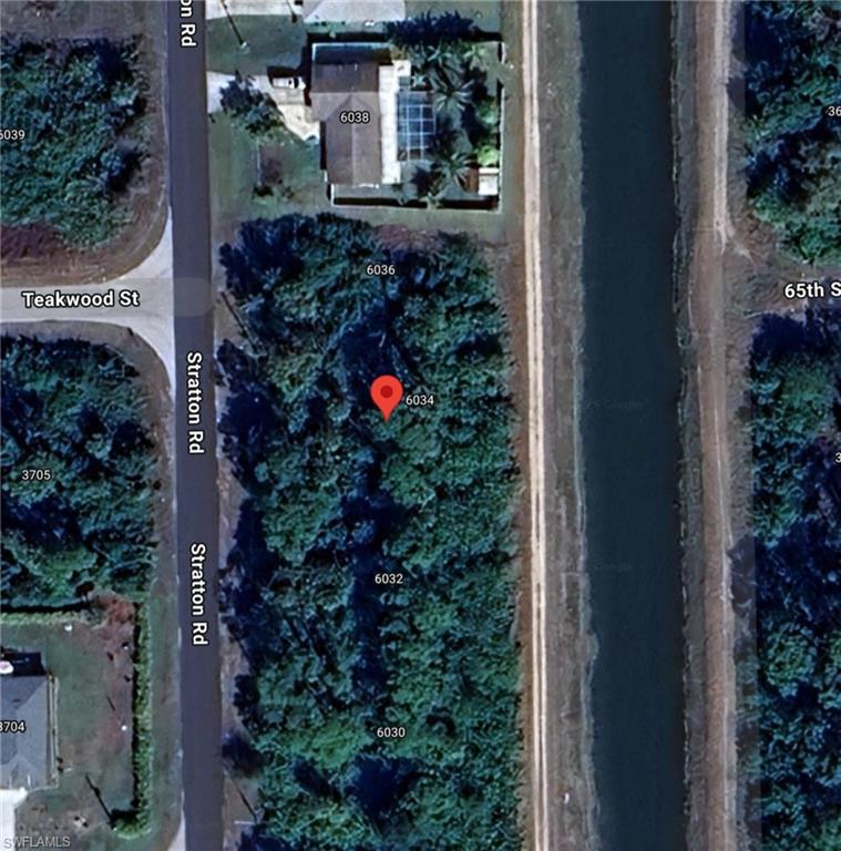 6034 Stratton Road Fort Myers, FL 33905 - Photo 1 of 1 an aerial view of a house with a flower garden