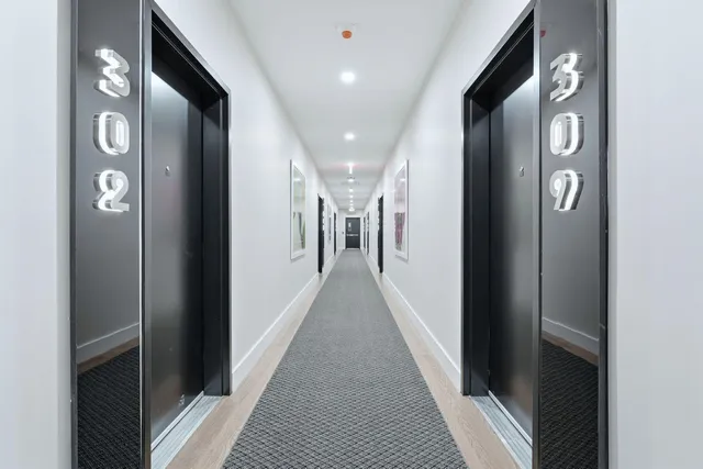 a room with gym equipment and large windows