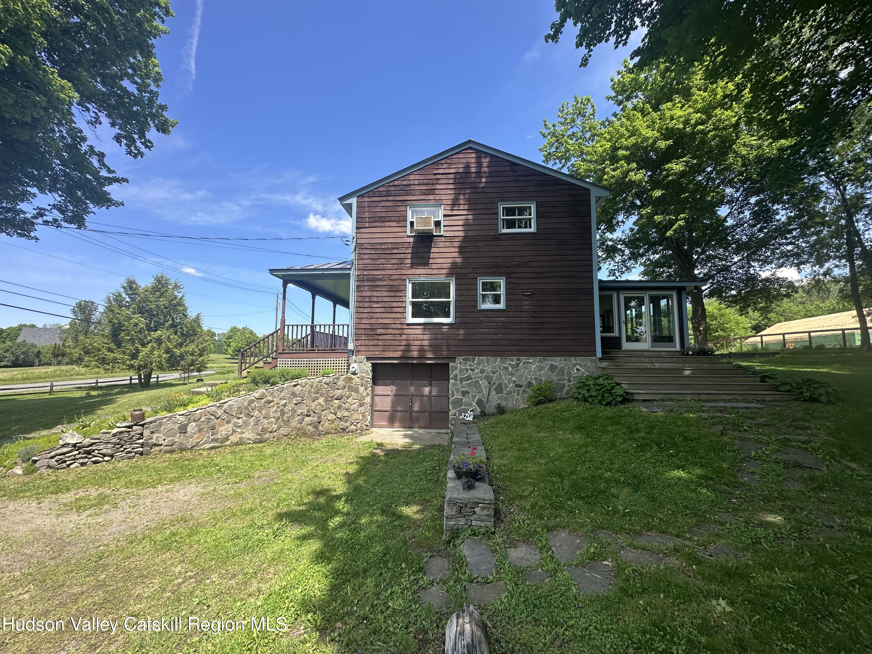 1492 County Road Copake, NY 12516 - Photo 24 of 34 a front view of a house with garden