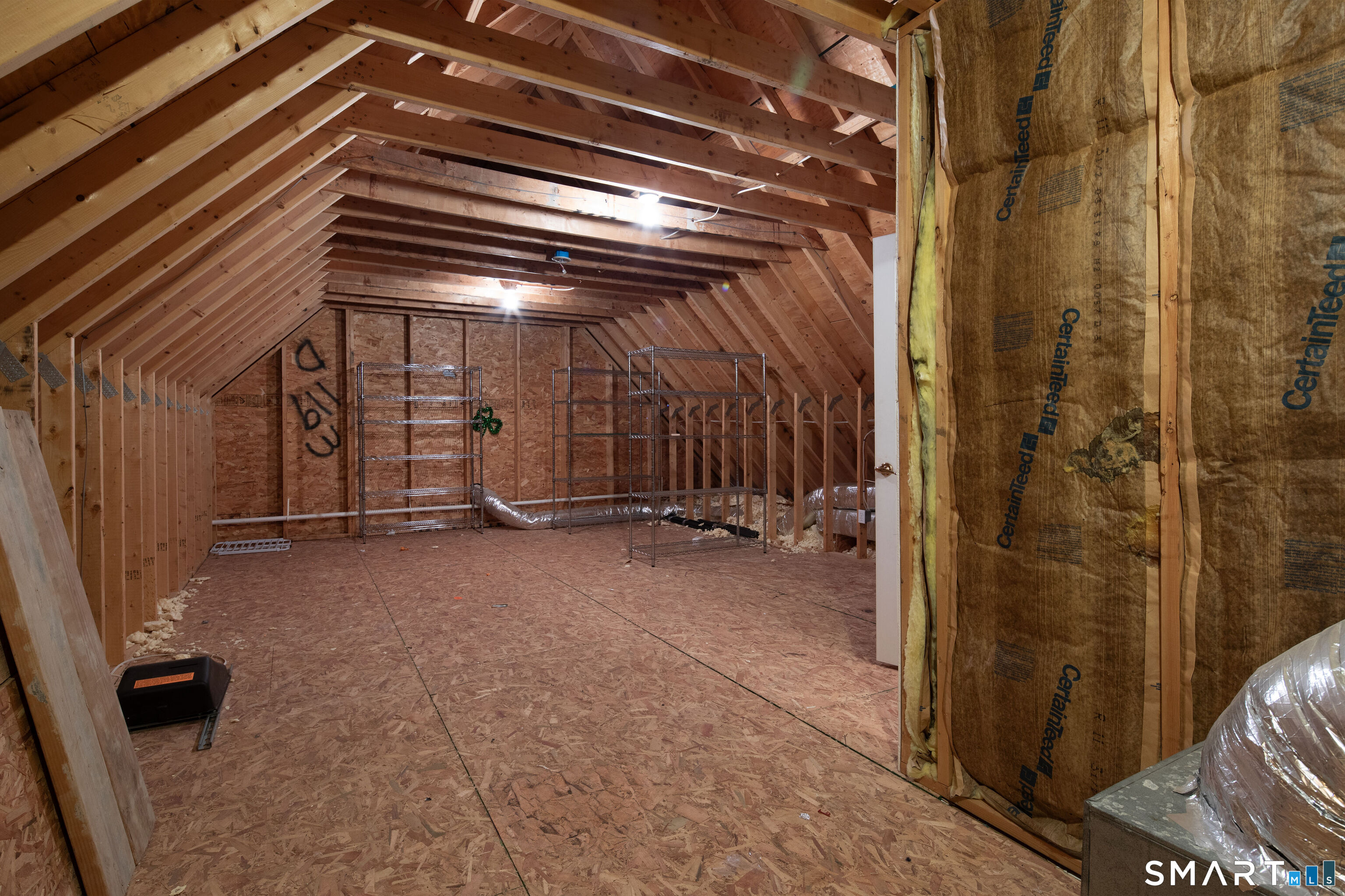 27 Smoke Ridge Drive Sherman, CT 06784 - Photo 32 of 40 On the second floor there is walk up access to an attic with great potential to develope a new space or for storage.