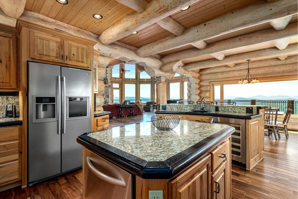 373 Rising Star Lane Mineral Bluff, GA 30559 - Photo 45 of 98 a kitchen with stainless steel appliances granite countertop a table chairs and a refrigerator