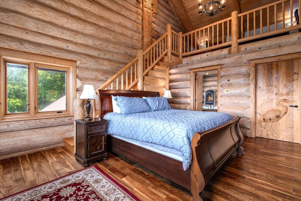 373 Rising Star Lane Mineral Bluff, GA 30559 - Photo 62 of 98 a bedroom with a bed and a large window with wooden floor