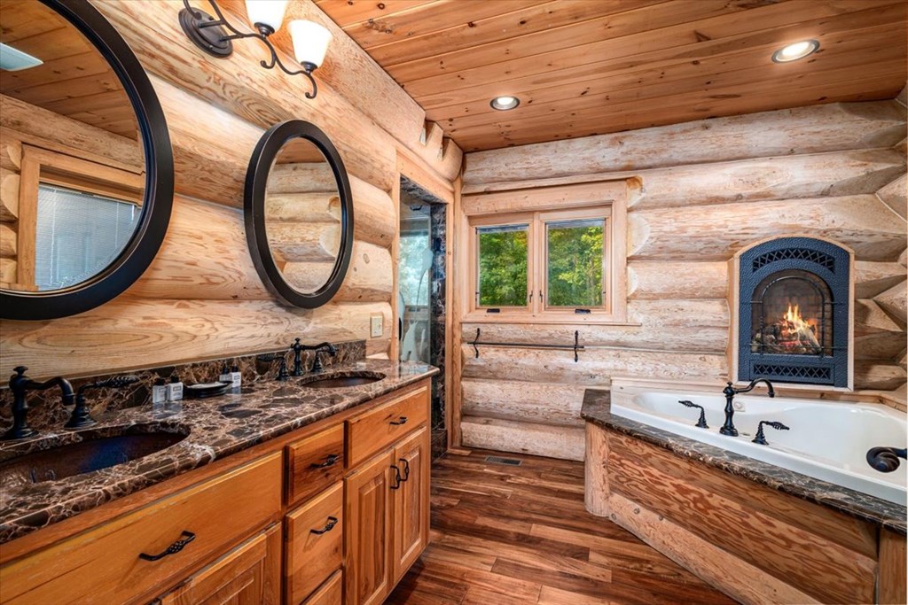 373 Rising Star Lane Mineral Bluff, GA 30559 - Photo 78 of 98 a bathroom with a granite countertop sink and a large mirror
