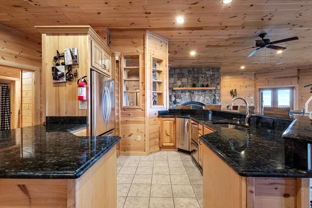 373 Rising Star Lane Mineral Bluff, GA 30559 - Photo 82 of 98 a large kitchen with stainless steel appliances granite countertop a sink and cabinets