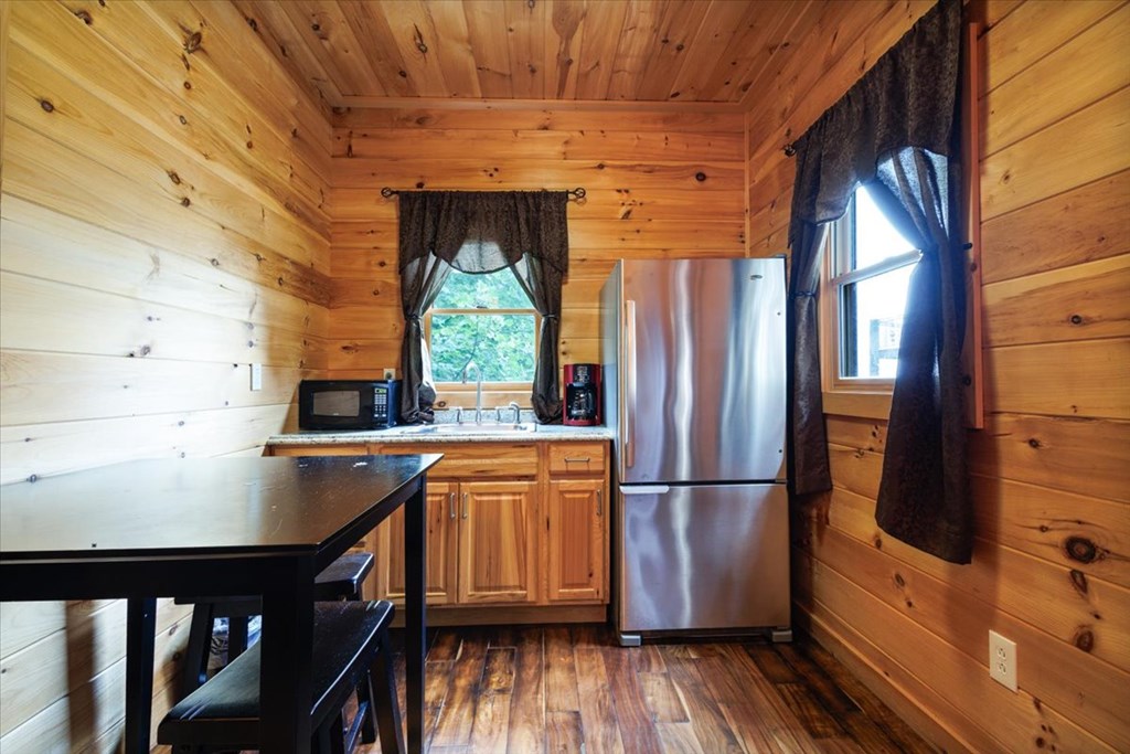 373 Rising Star Lane Mineral Bluff, GA 30559 - Photo 97 of 98 a kitchen with stainless steel appliances granite countertop a refrigerator a sink and wooden floors