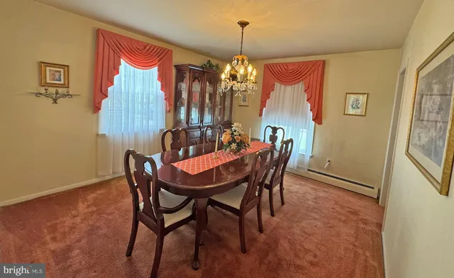 a dining room with furniture and window