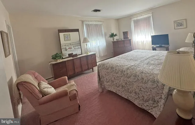 a living room with furniture and painting on the wall