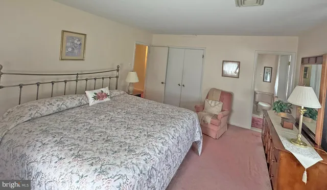 a bedroom with a bed a couch and dresser