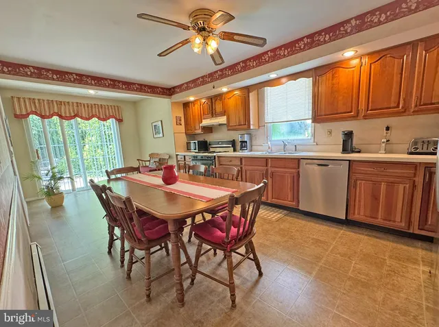 a dining table with chairs and window