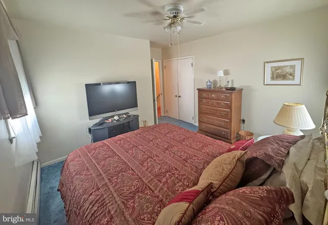 a bedroom with a bed and dresser with mirror