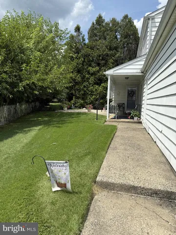 a view of a patio with a table and chairs under an umbrella